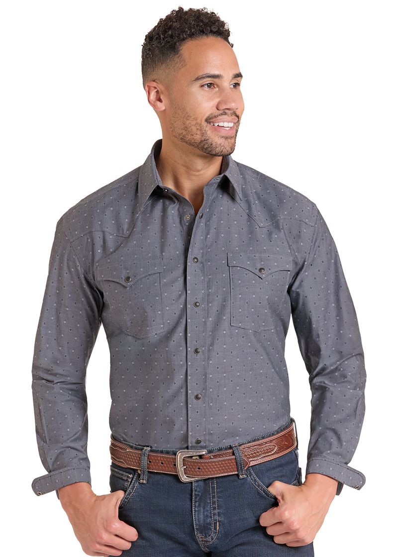 A man wearing a dark gray long-sleeve western-style button-down shirt with a subtle micro-dot pattern, paired with blue jeans and a brown leather belt.