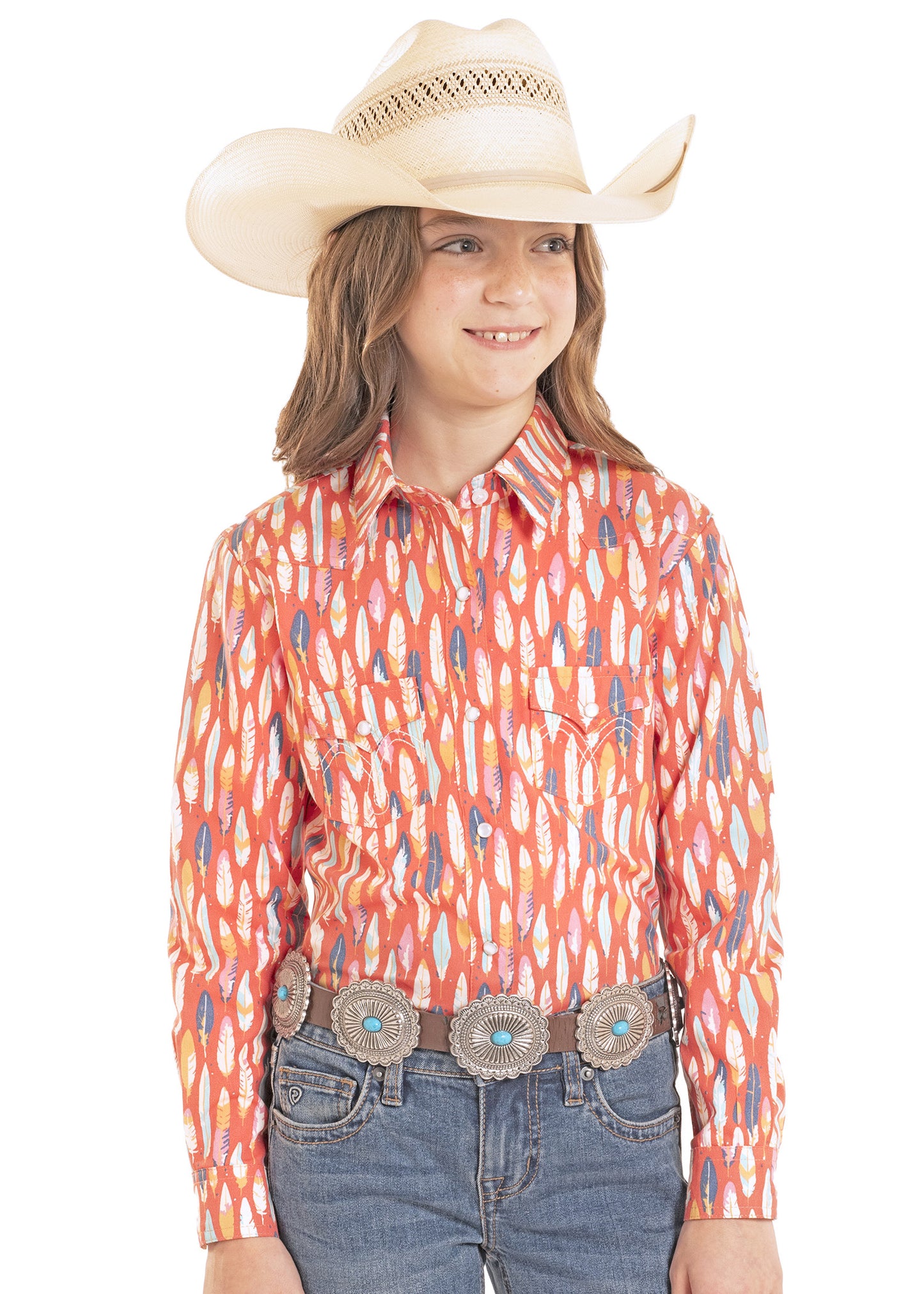 Child wearing a colorful patterned shirt, jeans, and a cowboy hat on a white background