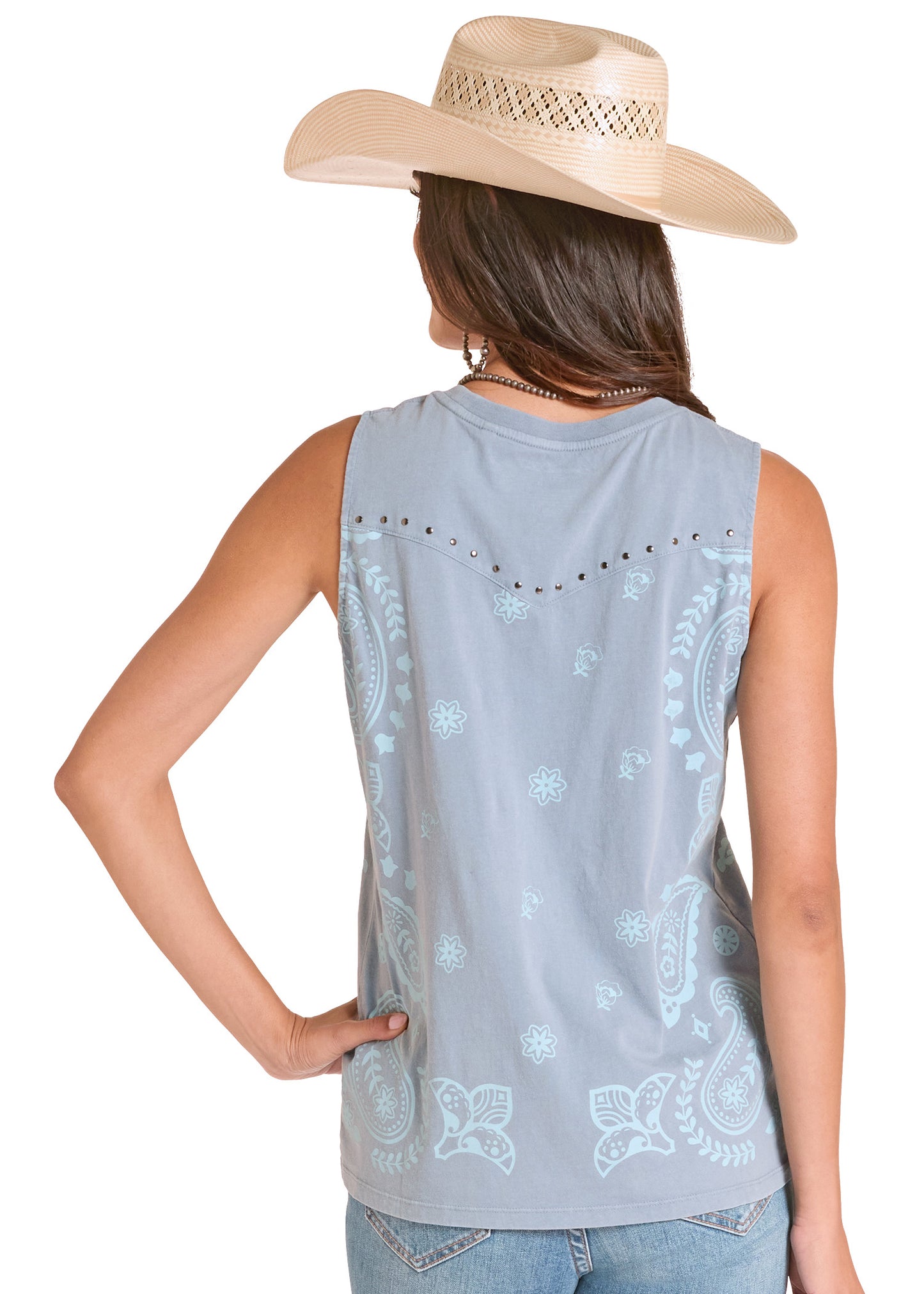 Woman wearing a sleeveless light blue top with bandana pattern and a beige cowboy hat on a white background