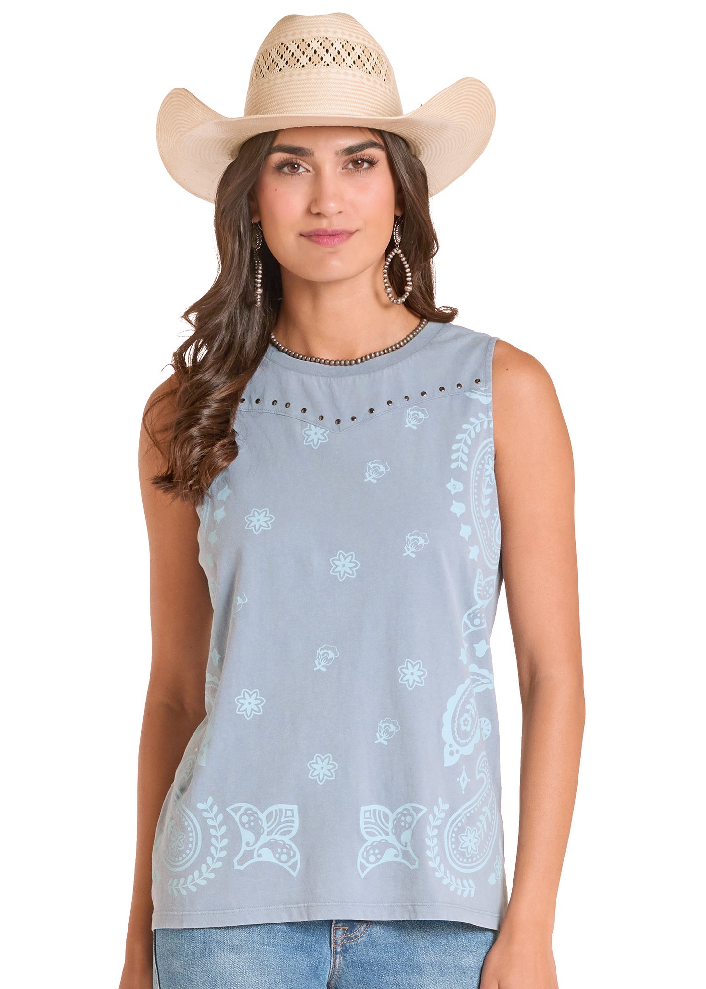 Woman wearing a light blue sleeveless top with white patterns and a beige cowboy hat on a white background