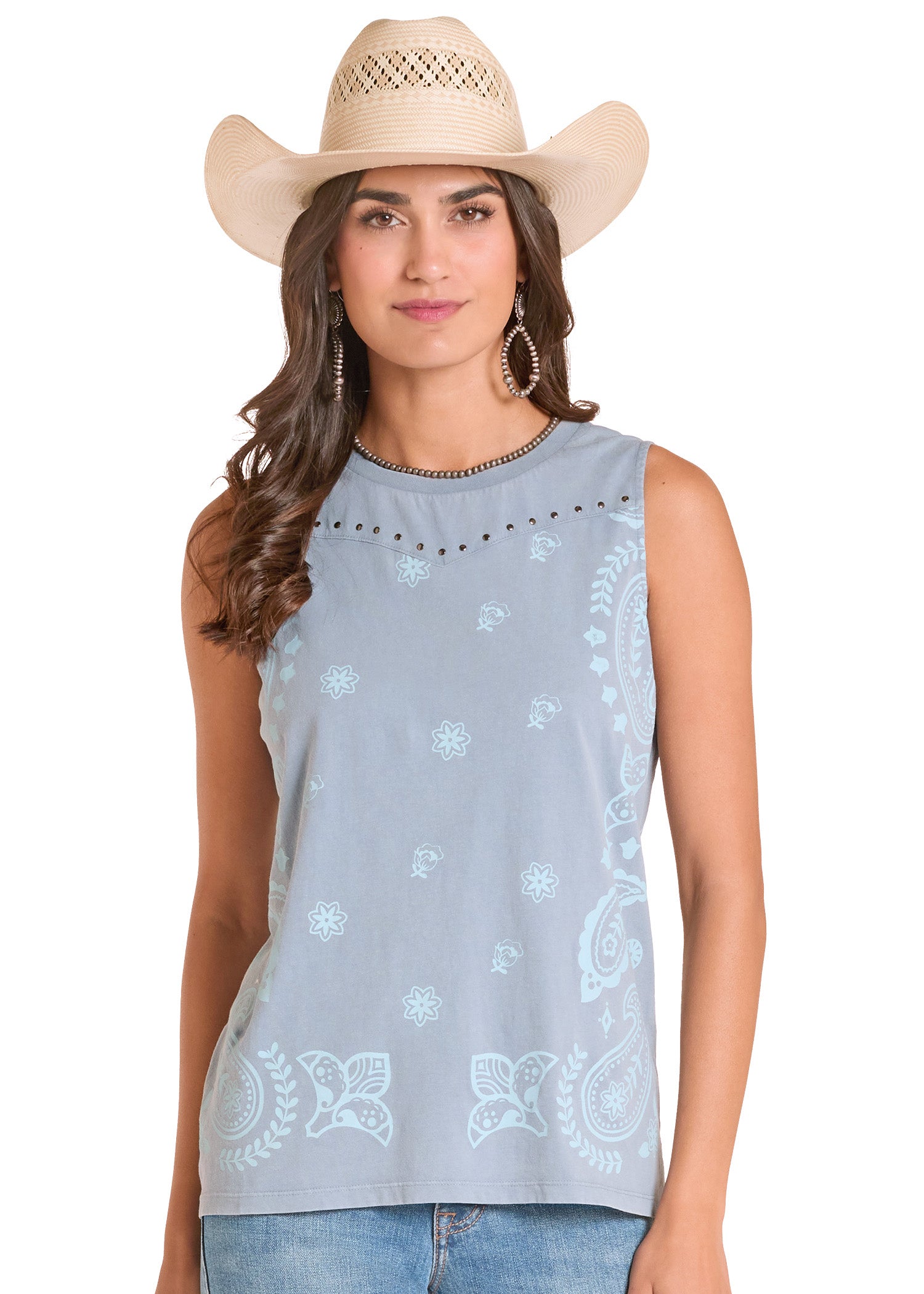 Woman wearing a light blue sleeveless top with white patterns and a beige cowboy hat on a white background