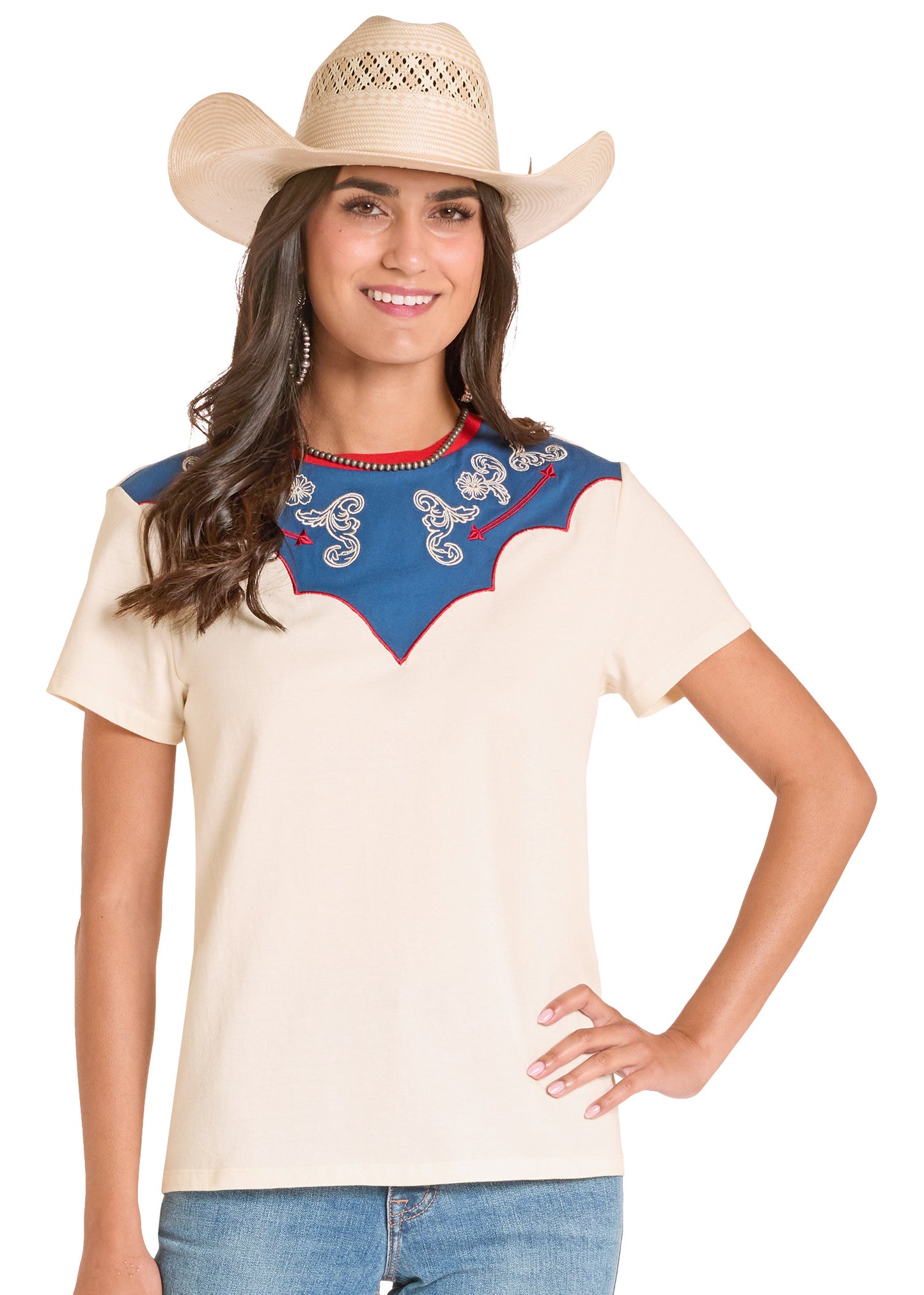 Woman wearing a cream-colored top with blue embroidery and a cowboy hat on a white background