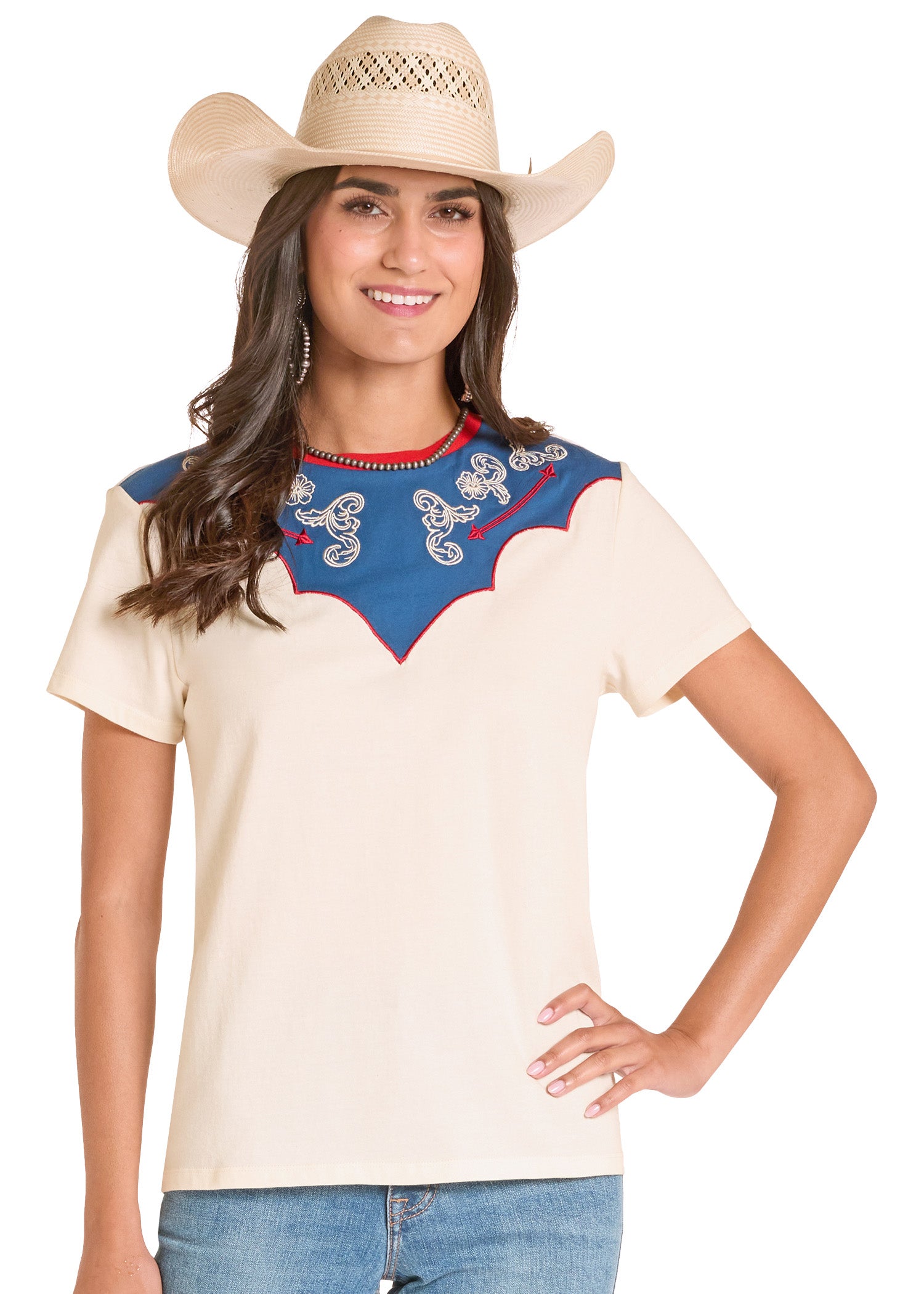 Woman wearing a cream-colored top with blue embroidery and a cowboy hat on a white background