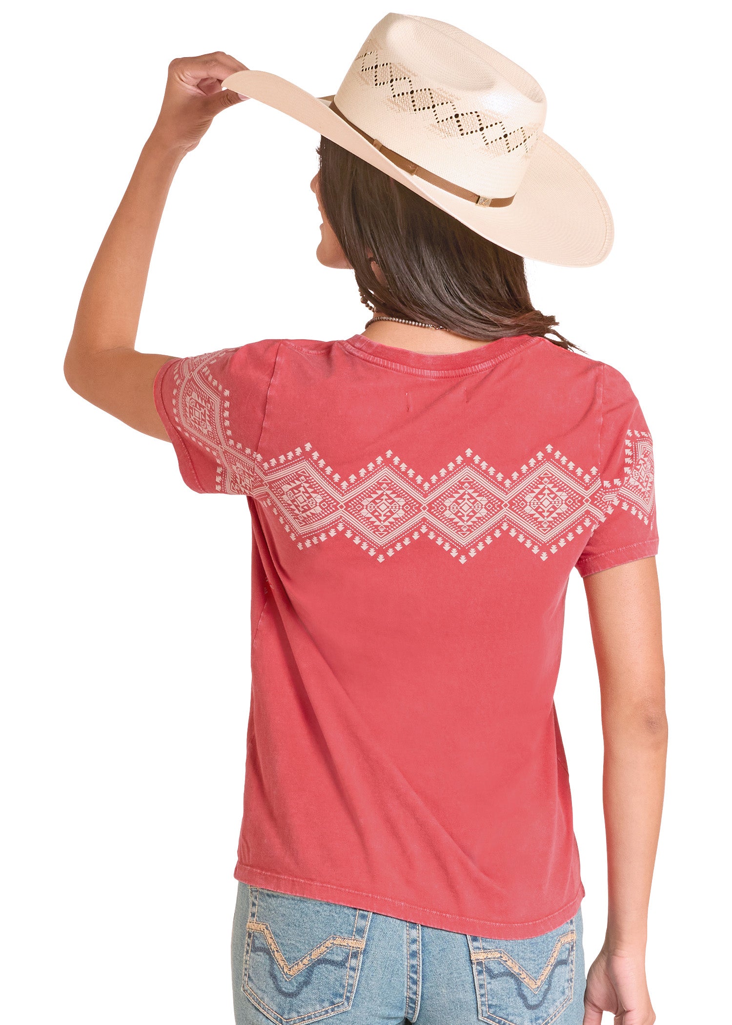 Woman wearing a red t-shirt with white patterns and a beige hat on a white background