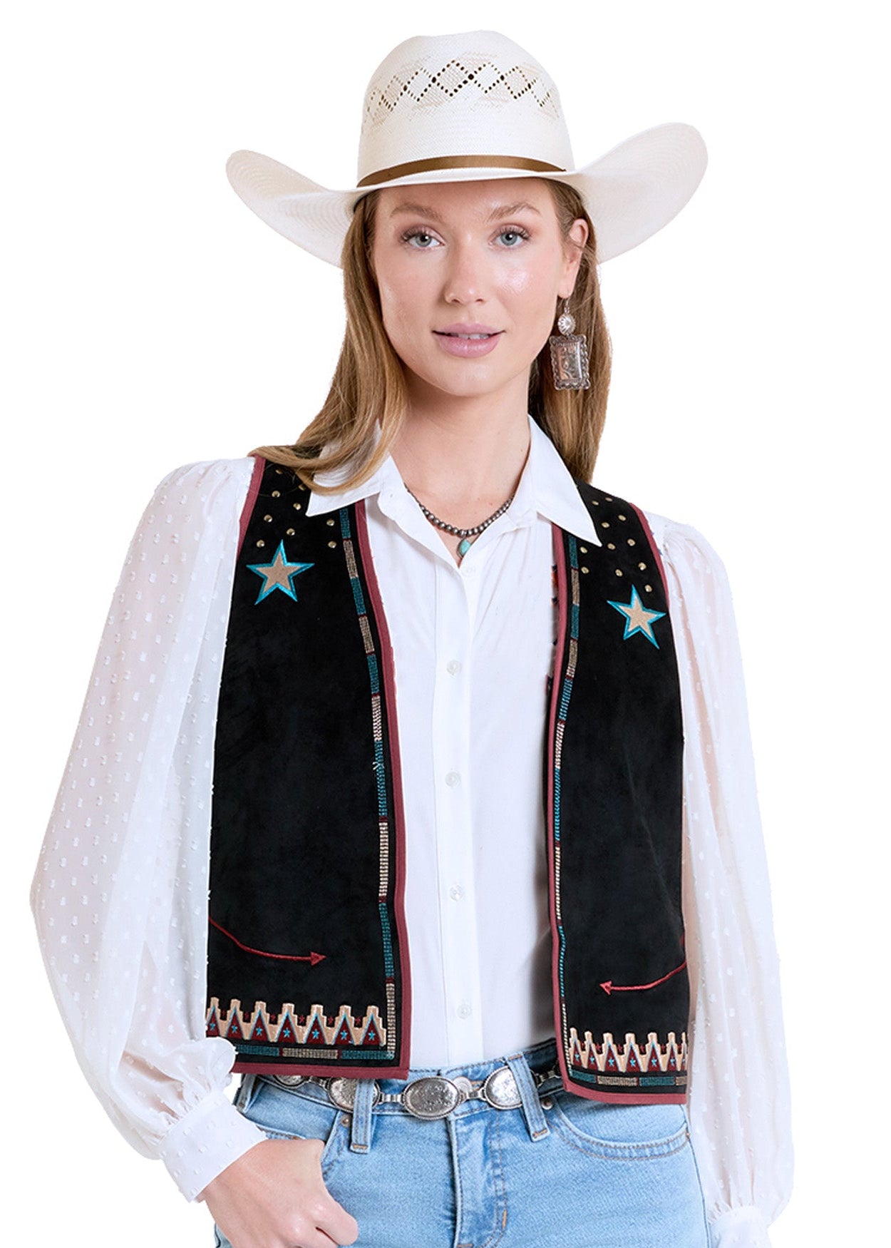Woman wearing a black embroidered vest with star designs, white shirt, blue jeans, and cowboy hat on a white background.