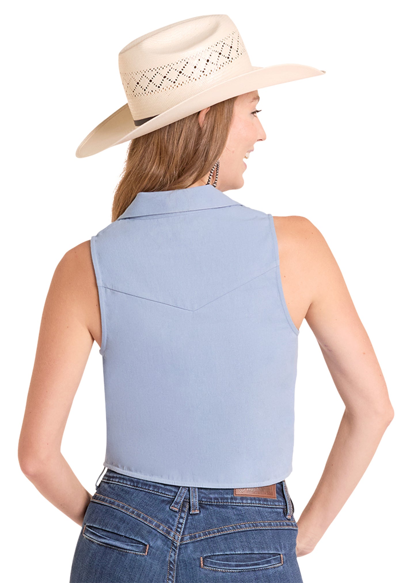 Woman wearing a light blue sleeveless shirt and beige cowboy hat on a white background