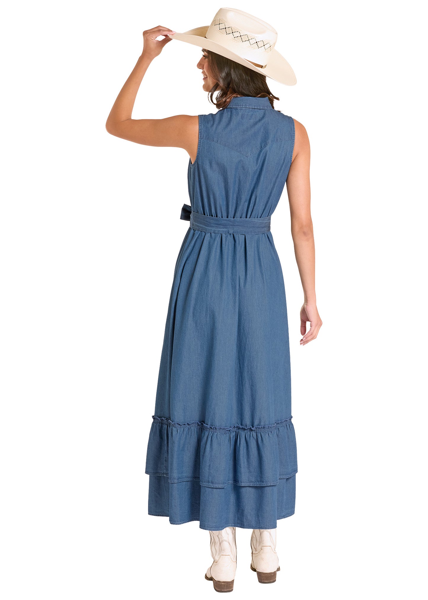 Woman wearing a blue dress and white boots, holding a hat on a white background