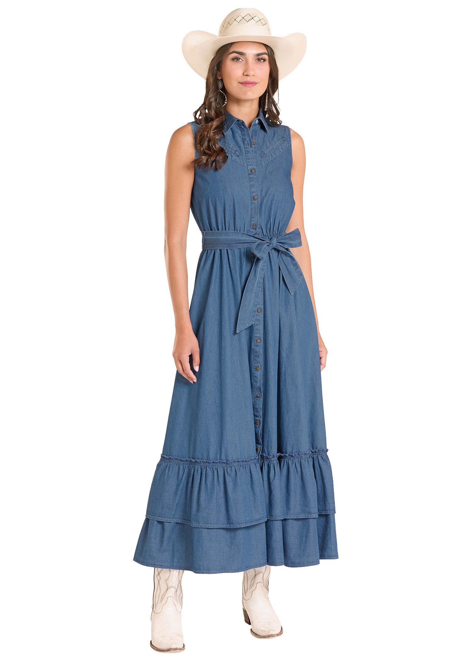Woman wearing a blue dress with a belt and white boots on a white background