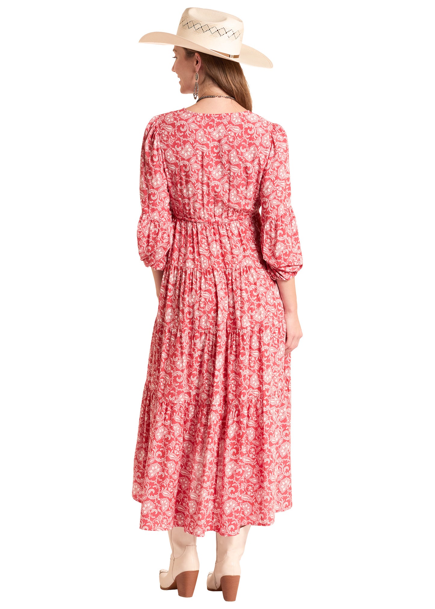Woman wearing a red floral dress and beige hat on a white background