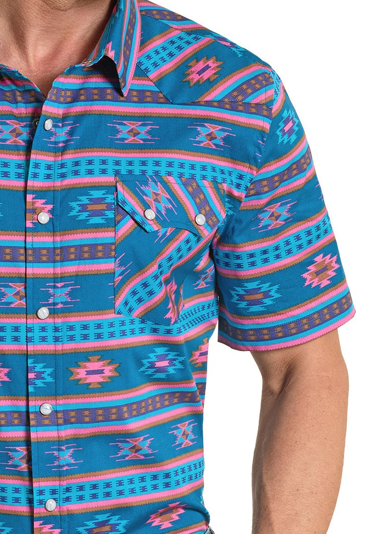 Man wearing a colorful patterned shirt and cowboy hat on a white background