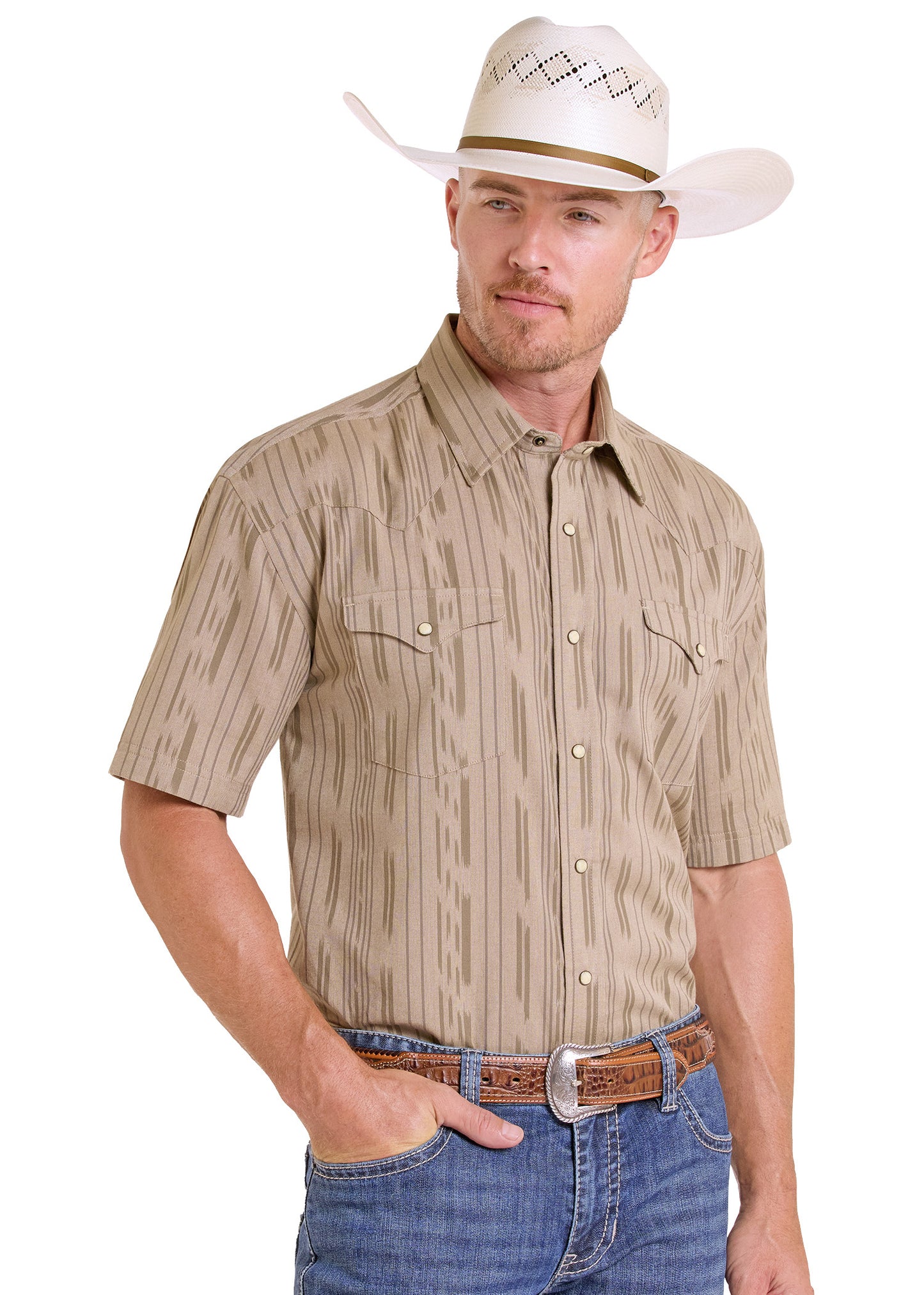 Man wearing a beige short-sleeve shirt with a pattern, blue jeans, and a white cowboy hat on a white background