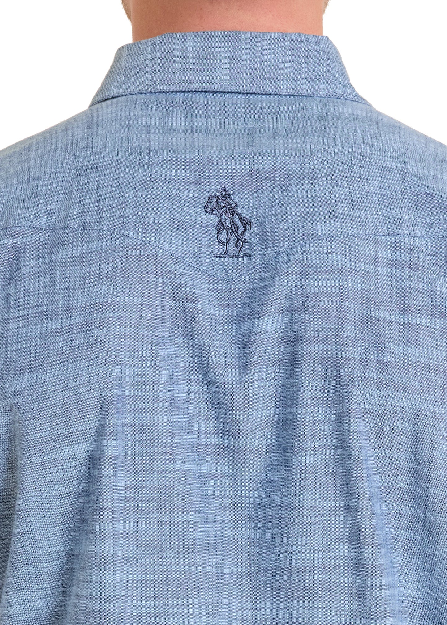 Close-up of a blue checkered shirt with a logo on the chest pocket against a white background