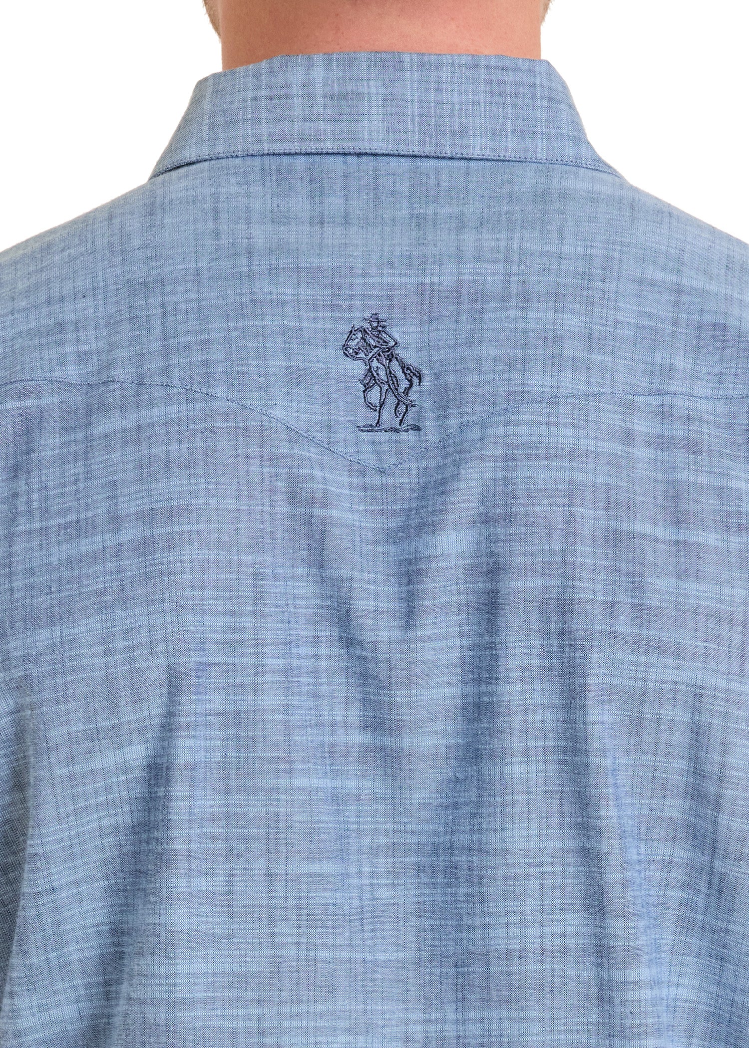 Close-up of a blue checkered shirt with a logo on the chest pocket against a white background