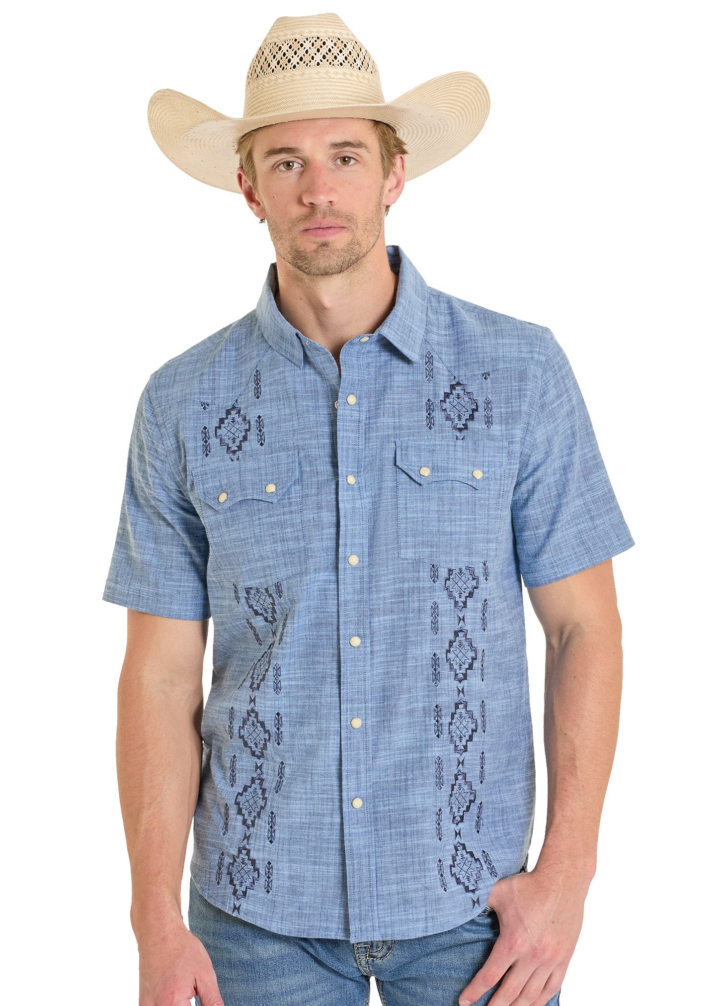 Man wearing a blue embroidered shirt and cowboy hat on a white background