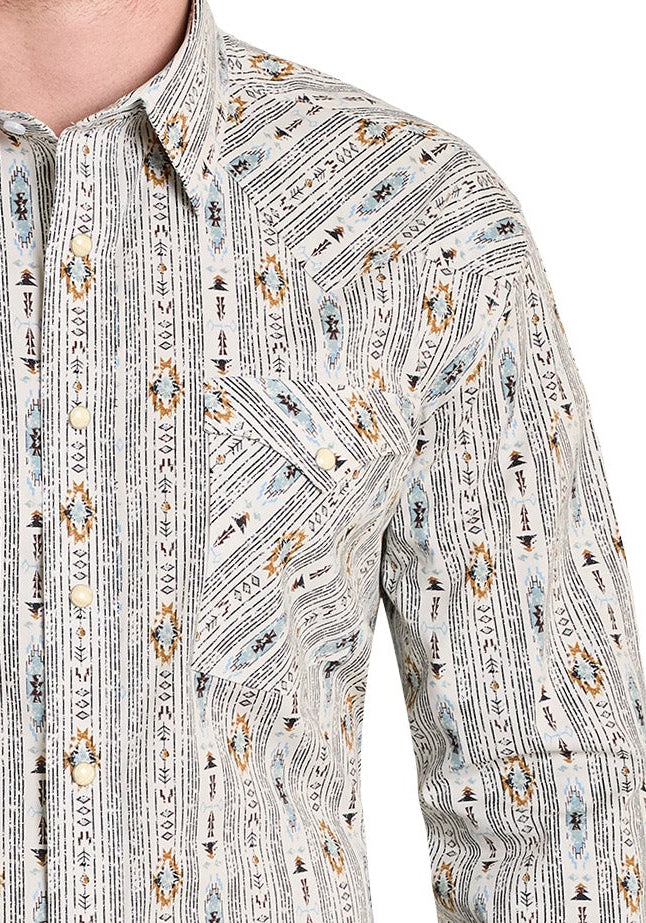 Man wearing a patterned long-sleeve shirt and jeans on a white background