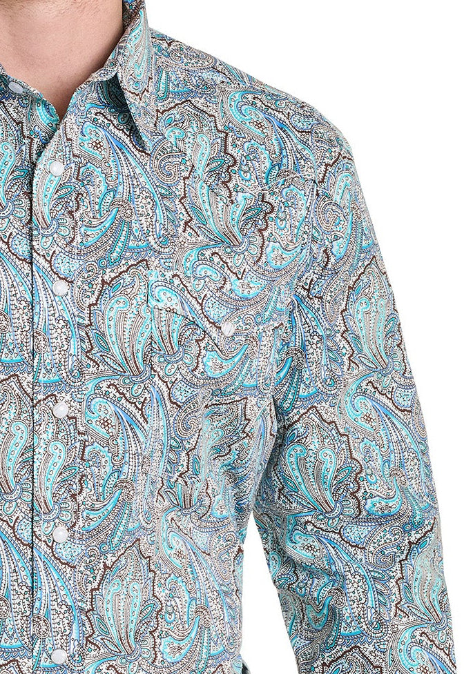 Man wearing a patterned shirt and jeans on a white background