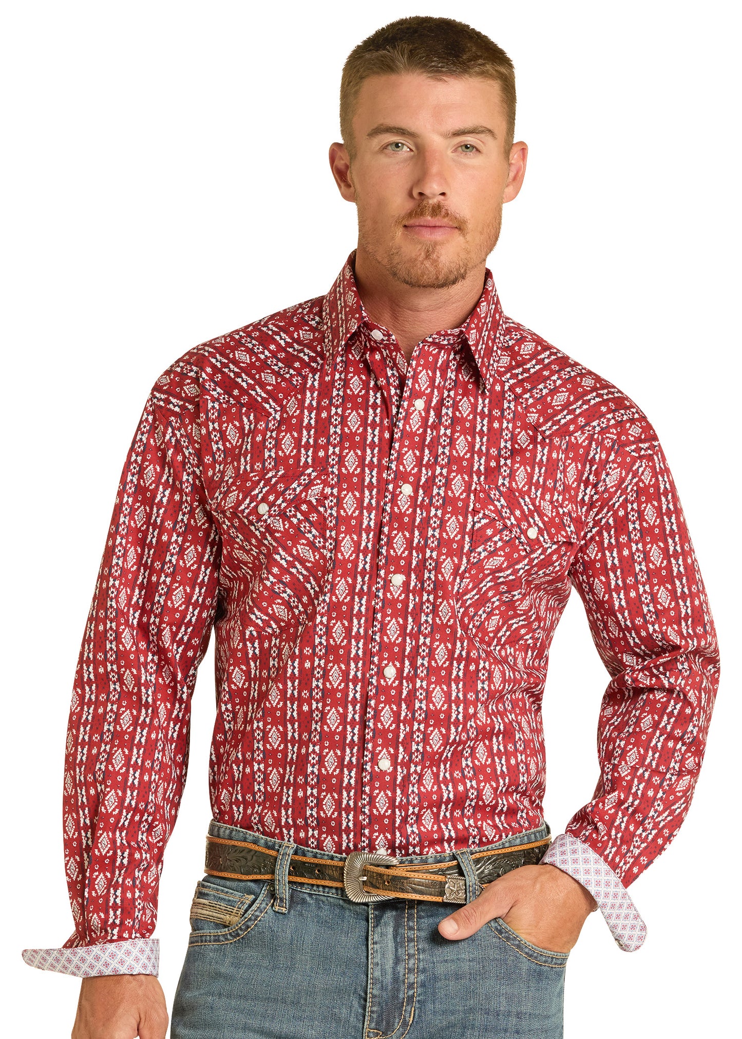 Man wearing a red patterned shirt and jeans on a white background