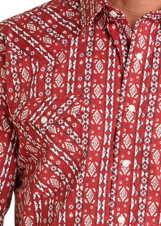 Man wearing a red patterned shirt and jeans on a white background