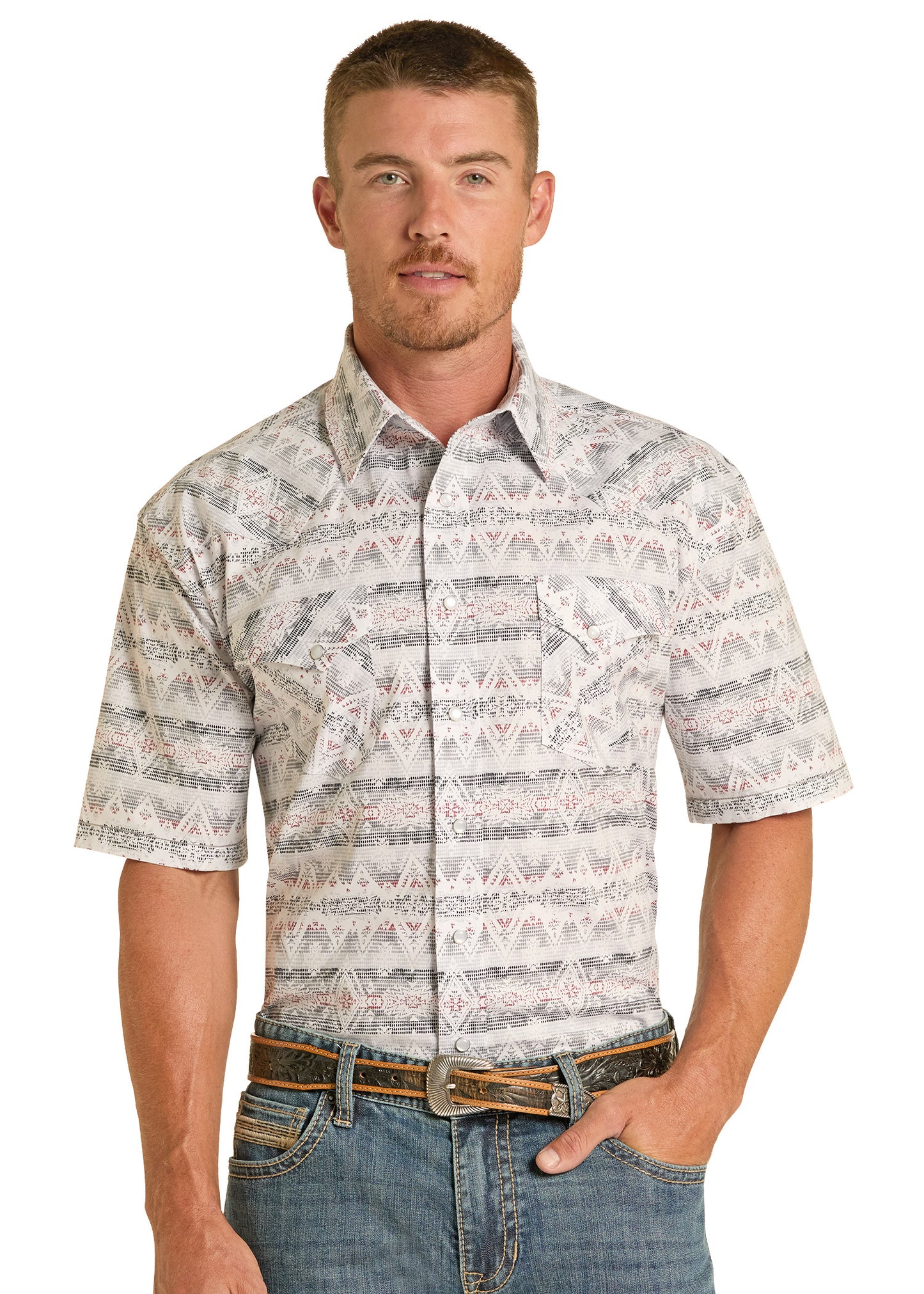 Man wearing a patterned short-sleeve shirt and jeans on a white background
