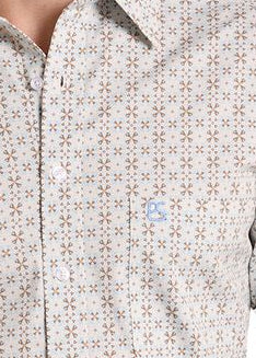 Detail of the a western-style button-down shirt with a small geometric pattern in beige and brown.